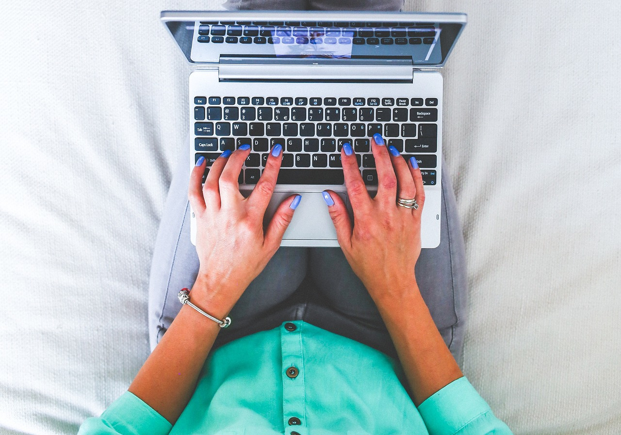WordPress for Authors: Build a High-Converting Site | Woman typing on laptop keyboard.