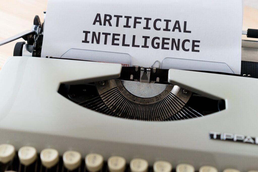 Typewriter with a sheet reading "ARTIFICIAL INTELLIGENCE" visible.